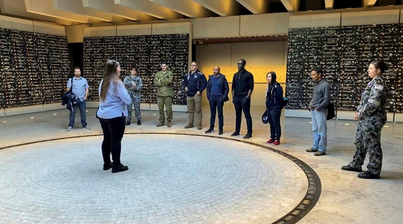 Ashleigh Taylor, from the Anzac Memorial, guides ADF Cyber Gap Program participants around the memorial in Sydney's Hyde Park.