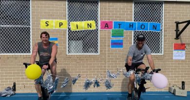 Petty Officer Simon Taylor, left, and Lieutenant Commander James Knight compete in the HMAS Watson spin-a-thon fundraiser for Dry July. Story by Lieutenant Kiz Welling-Burtenshaw.