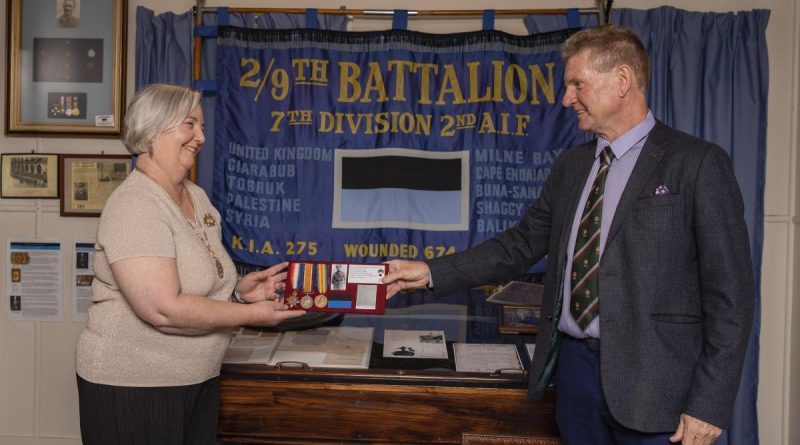 Len Kelly returns the medals of World war I veteran Lieutenant Norman Weynand to his family member Lynne Bennett at the 9th Battalion Museum at Gallipoli Barracks Brisbane. Story by Corporal Olivia Cameron.