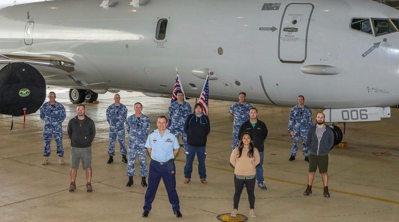 Officer Commanding No. 92 Wing, Group Captain John Grime, front centre, stands with staff and personnel from Surveillance and Response Systems Program Office, No. 92 Wing and Boeing in front of P-8A Poseidon A47-006. Story by Bettina Mears. Photo by Corporal Brenton Kwaterski.