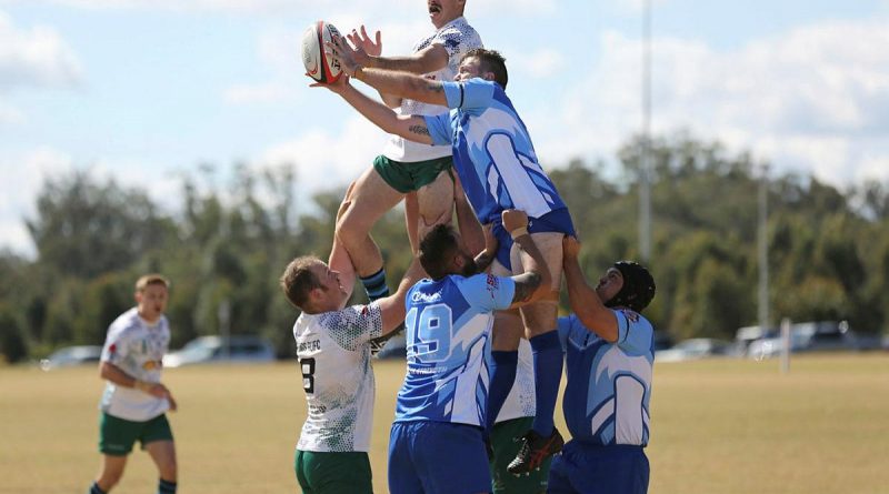 A player from the Royal Australian Corps of Signals Rugby Union Football Club team rises above a Toowoomba Police player in the annual Brett Forte Cup memorial rugby game in Queensland. Story by Flying Officer Evita Ryan. Photo by Corporal Joshua Thomas.