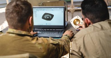 Specialist soldiers use a WarpSPEE3D Tactical printer to make a wheel-bearing hub for an M-113 APC at Bradshaw Field Training Area, NT, during Exercise Koolendong. Photo supplied. 