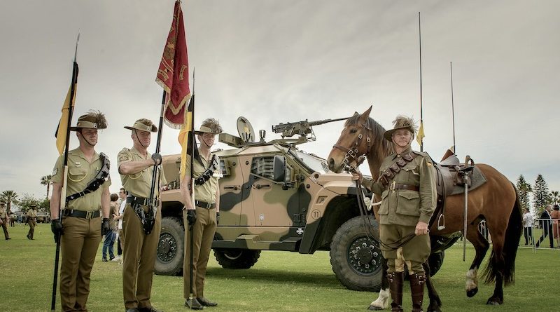 Members of the 10th Light Horse Regiment and the 10th Light Horse Memorial Troop stand in front of the regiments modern steed. Photo by Sergeant Gary Dixon.