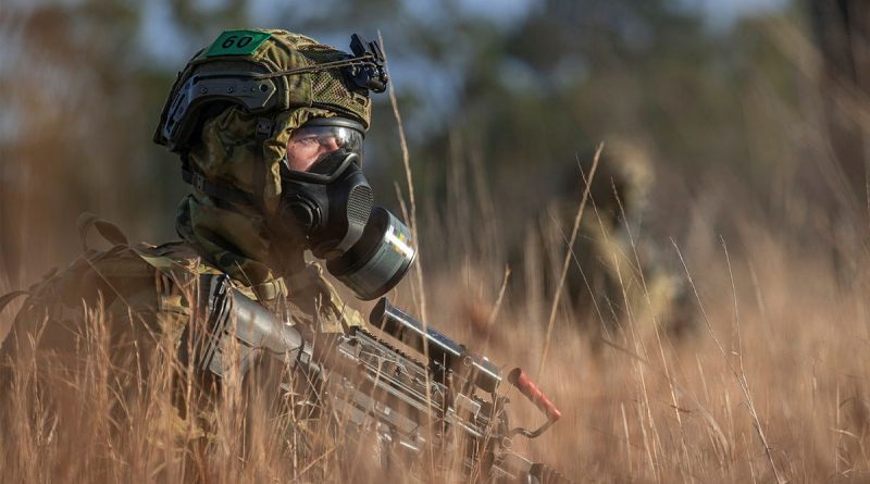 A soldier from the 6th Battalion, Royal Australian Regiment, patrolling during a simulated chemical, biological, radiological, nuclear survival training exercise at Townsville Field Training Area, Queensland. Story by Captain Taylor Lynch. Photo by Corporal Nicole Dorrett.