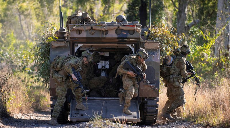 Sappers from the 2nd Combat Engineer Regiment dismount an Australian Army M113AS4 Armoured Personnel Carrier to conduct a simulated breach of an enemy position while training at Townsville Field Training Area, Queensland. Photo by Corporal Nicole Dorrett.