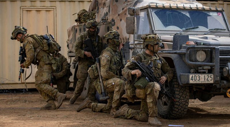 Soldiers from the 6th Battalion, Royal Australian Regiment, take cover behind an Australian Army G Wagon while conducting building clearances during urban operations training at Townsville Field Training Area, Queensland. Story by Captain Taylor Lynch. Photo by Corporal Nicole Dorrett.