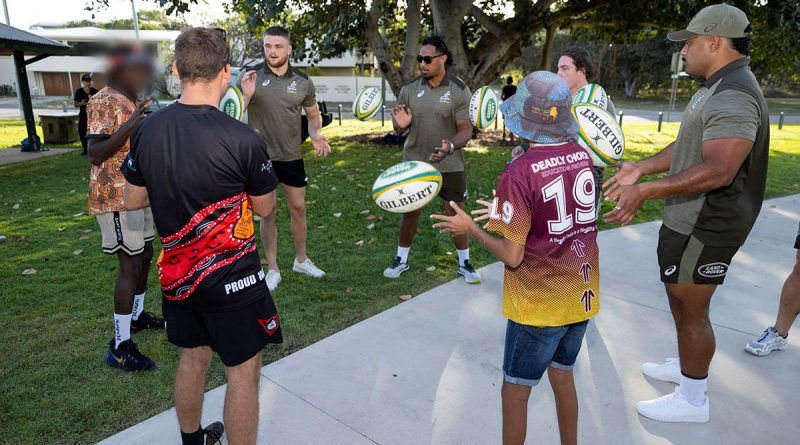 Players from the Wallabies Rugby team throw footballs with participants of the Proud Warrior Youth Engagement Program at Pallarenda Beach, Queensland on 23 September 2021. Story by Captain Lily Charles. Photo by Corporal Brandon Grey.