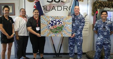Commanding Officer No. 383 Squadron Wing Commander Alan Brown, centre right, and RAAF Base Townsville Indigenous liaison officer Flight Lieutenant David Williams with artist Kailin Kyle, centre, Stars Foundation's Emma Ferguson, left, and Jean Murphy. Story by Flying Officer Robert Hodgson.