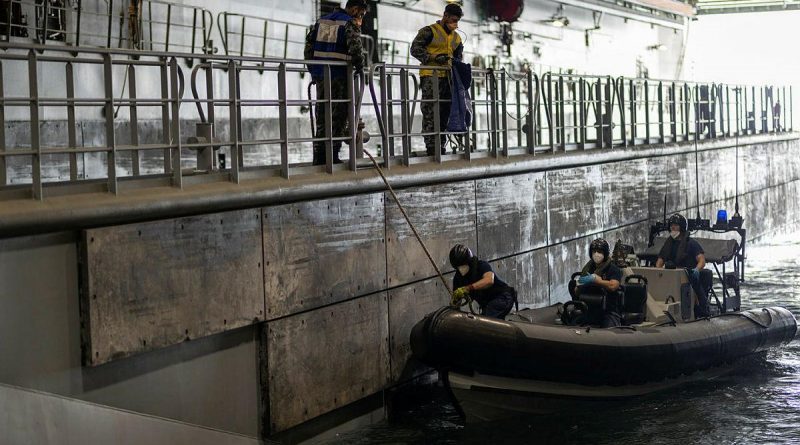 Crew members from HMS Diamond conduct a contactless boat-landing exercise with HMAS Canberra personnel during Exercise Bersama Gold 21. Story by Captain Peter March. Photo by Petty Officer Christopher Szumlanski.