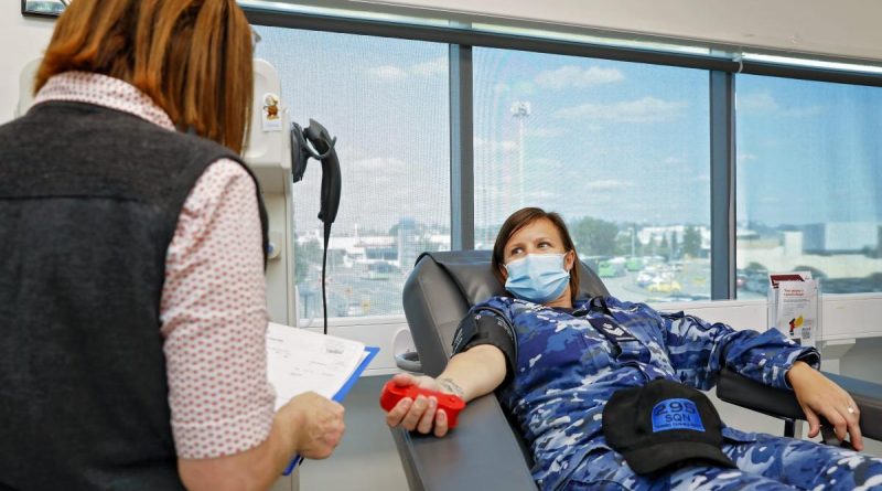 Enrolled nurse Nicole Gentry prepares Flight Sergeant Kate Morris, of No. 295 Squadron, for her plasma donation at the Red Cross Ipswich Donation Centre in Queensland. Story by Flight Lieutenant Jessica Aldred. Photo by Corporal Nicci Freeman.