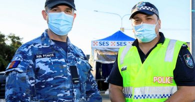 Flying Officer Brett Smith talks with his mate and former colleague Senior Constable Jared Cowan at the Gold Coast Highway police checkpoint. Story by Lieutenant Nicolas Hawkins. Photo by Corporal Brett Sherriff.