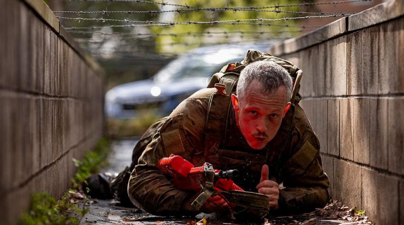 A soldier from the 7th Combat Brigade crawls under barbed wire during the 7th Combat Brigade Commander's Cup obstacle course competition at Gallipoli Barracks, Brisbane. Story b y Captain Taylor Lynch. Photo by Corporal Nicole Dorrett.