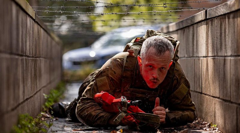 A soldier from the 7th Combat Brigade crawls under barbed wire during the 7th Combat Brigade Commander's Cup obstacle course competition at Gallipoli Barracks, Brisbane. Story b y Captain Taylor Lynch. Photo by Corporal Nicole Dorrett.