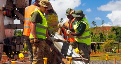 Captain Thomas Sefton, front, and other members of the ADF construction engineer team place concrete into the footings of a new classroom building at Lekutu Secondary School in Fiji. Story by Captain Michael Trainor.
