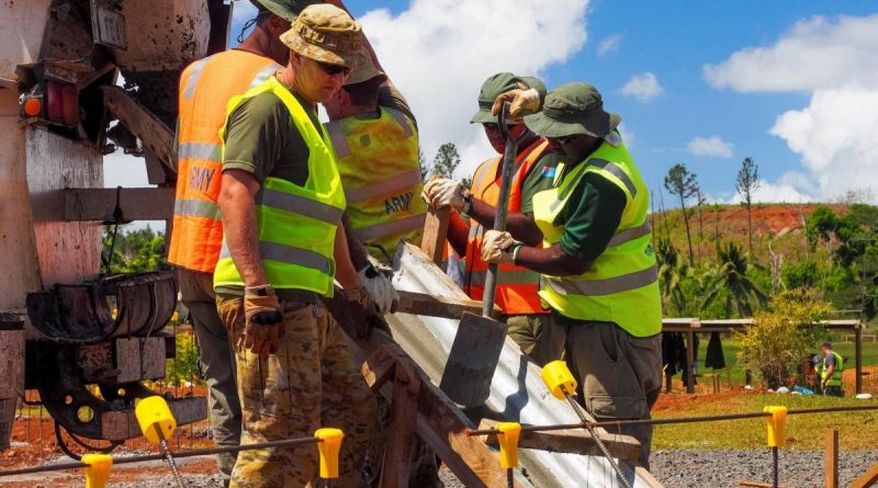 Captain Thomas Sefton, front, and other members of the ADF construction engineer team place concrete into the footings of a new classroom building at Lekutu Secondary School in Fiji. Story by Captain Michael Trainor.