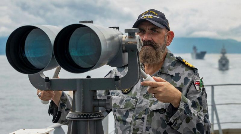 Lieutenant Commander Richard Mingramm looks out from the starboard bridge wing of HMAS Sirius, as the ship departs Cam Rah Bay, Vietnam, during Indo-Pacific Endeavour 2021. Story by Captain Peter March. Photo by Leading Seaman Sittichai Sakonpoonpol.