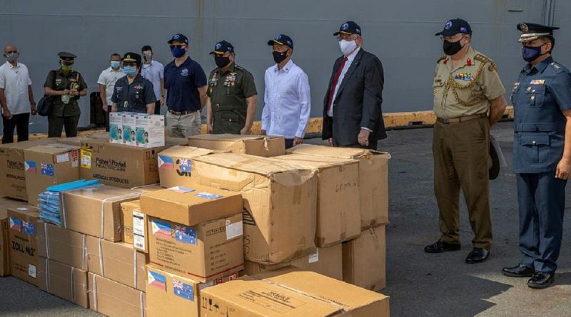 Personnel from HMAS Canberra deliver personal protective equipment to Manila, Philippines, during Indo-Pacific Endeavour 2021. Story by Captain Peter March. Photo by Petty Officer Christopher Szumlanski.