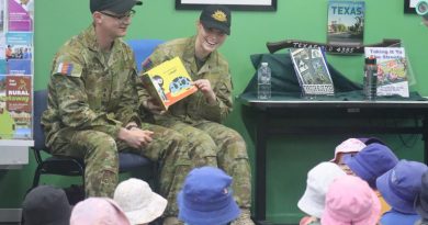 Lieutenant Thomas McAllister and Private Nikita Booth read a story to some children at the library in Texas, Queensland. Story by Captain Pete Conrad.