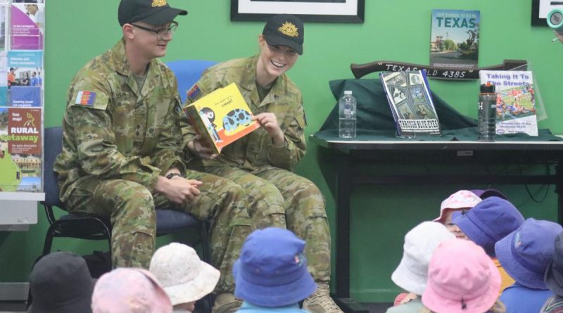 Lieutenant Thomas McAllister and Private Nikita Booth read a story to some children at the library in Texas, Queensland. Story by Captain Pete Conrad.