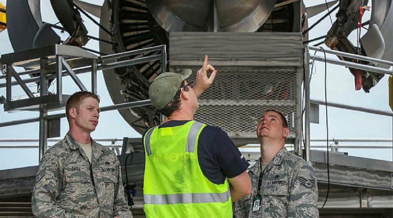 RAAF and US aviators discuss the maintenance of an aircraft. Story by Squadron Leader Barrie Bardoe.
