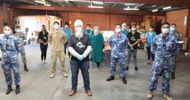Turbans 4 Australia President Amar Singh with ADF members at the charity's warehouse in Clyde, NSW. Story by Lieutenant Brendan Trembath.