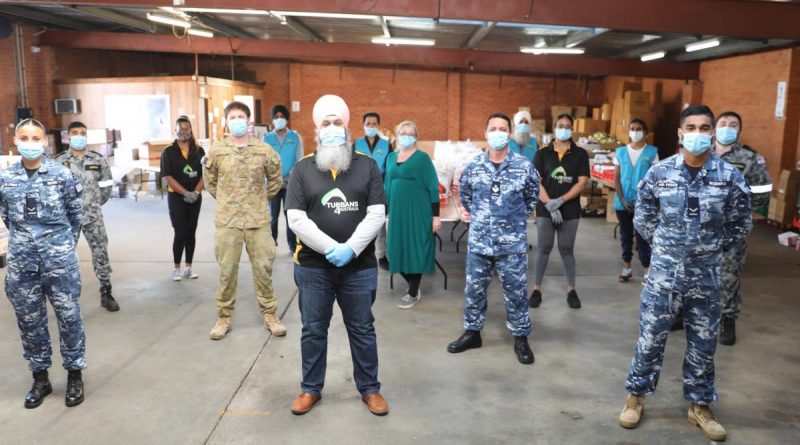 Turbans 4 Australia President Amar Singh with ADF members at the charity's warehouse in Clyde, NSW. Story by Lieutenant Brendan Trembath.