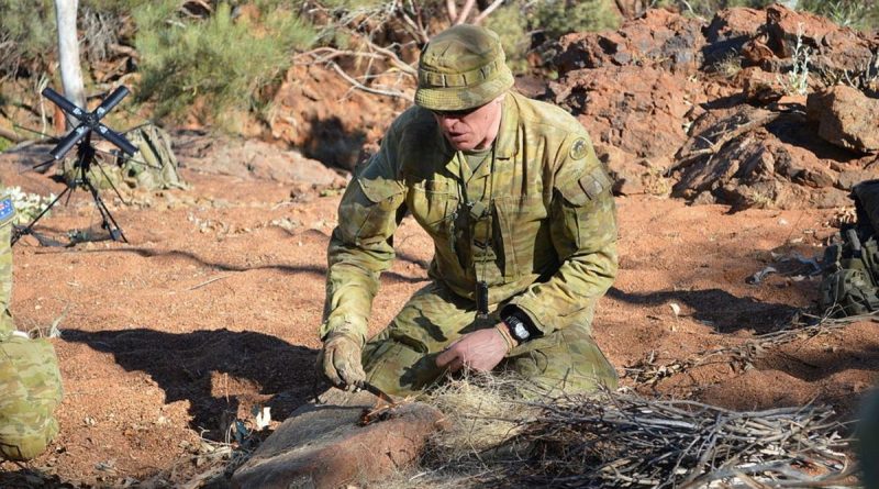 Corporal Andrew Ball demonstrates lighting a fire with a fero rod on Exercise Emu Walk. Story by Captain Sandra Seman-Bourke.