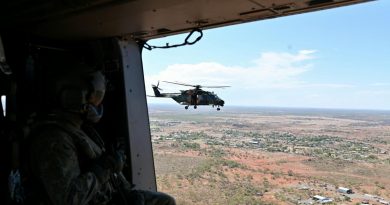 An Australian Army aircrewman from the 5th Aviation Regiment surveys the town of Cloncurry, from an MRH-90 Taipan helicopter. Story and photo by Captain Carolyn Barnett.