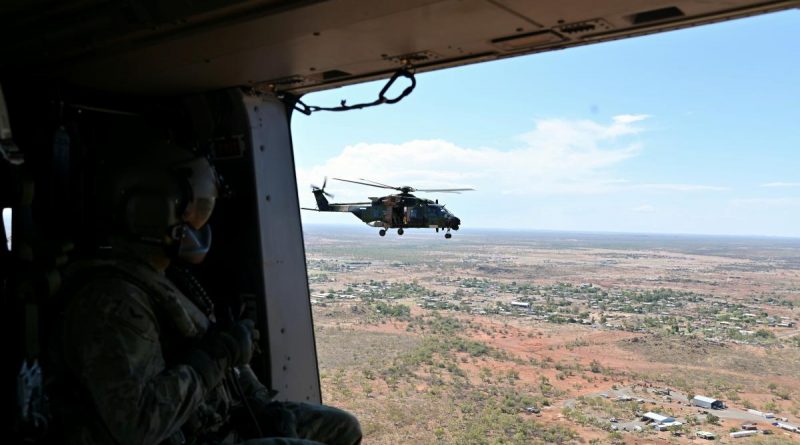 An Australian Army aircrewman from the 5th Aviation Regiment surveys the town of Cloncurry, from an MRH-90 Taipan helicopter. Story and photo by Captain Carolyn Barnett.