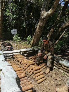 United States Marine Corps Chief Warrant Officer Class Two, Tony Delmont explains the procedure for unexploded ordnance disposal at the central demolition site, Badelboab, Palau.