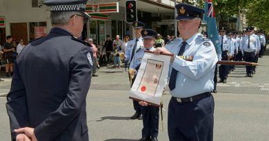 Warrant Officer John Markham, the parade Warrant Officer presents Assistant Commissioner Allan Adams with the Freedom of Entry scroll during No. 25 Squadron's Freedom of Entry parade in the City of Perth, Western Australia. Story by Flying Officer Robert Hodgson. Photo by Sergeant Gary Dixon.