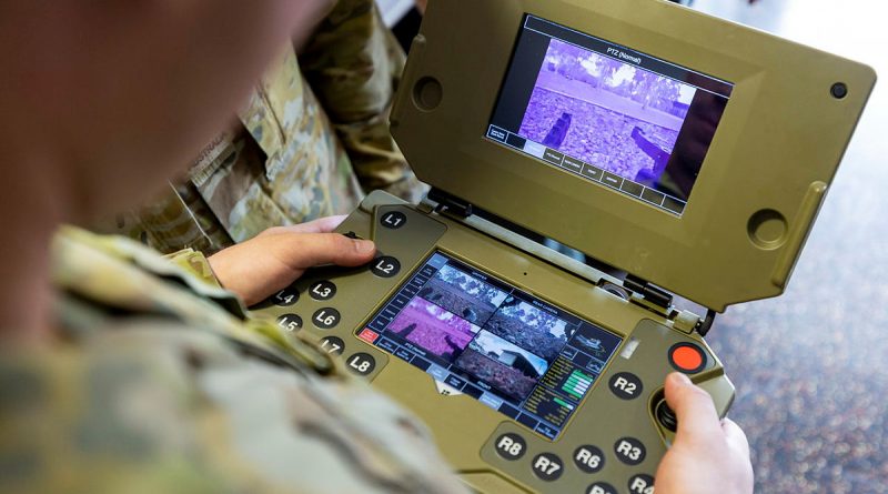 An Army Sapper runs tests on a robot control terminal focusing on autonomous systems , artificial intelligence and machine learning. Story by Edwina Callus. Photo by Corporal Brodie Cross.