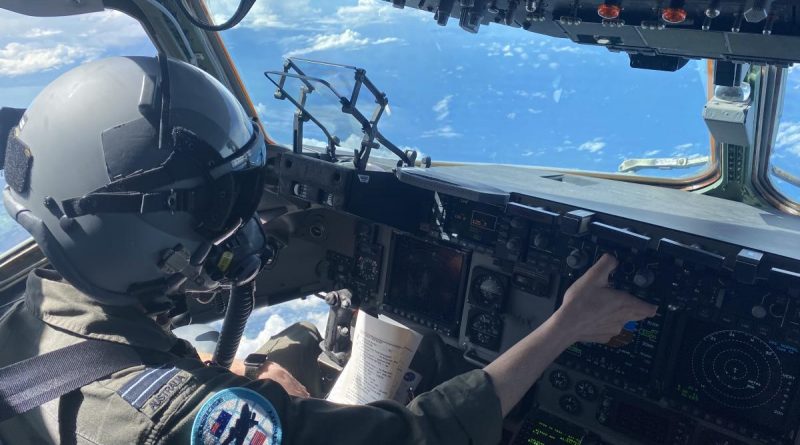 A RAAF pilot with No. 36 Squadron in the cockpit of a C-17A Globemaster during Exercise Global Dexterity 21. The helmet and oxygen mask are worn when performing airdrops. Story by Eamon Hamilton. Photo by Flight Lieutenant Matt Huber.