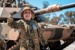 CAPTION: 11-year-old Adam celebrates after riding in an Australian Army M1A1 Main Battle Tank from the 2nd/14th Light Horse Regiment (Queensland Mounted Infantry).  Photo by Corporal Nicole Dorrett.