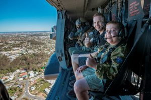 CAPTION: Sponsored by Make a Wish Foundation, 11-year-old Adam (right) and dad Robert enjoy a flight on an Australian Army MRH90 Taipan helicopter above Brisbane during his visit to Gallipoli Barracks, Brisbane, Queensland. Photo by Corporal Nicole Dorrett.