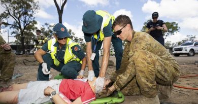 A soldier from the 3rd Combat Engineer Regiment helps Queensland Ambulance Service paramedics during a mass casualty scenario at Townsville field training area. Story by Captain Diana Jennings. Photo by Corporal Brandon Grey.