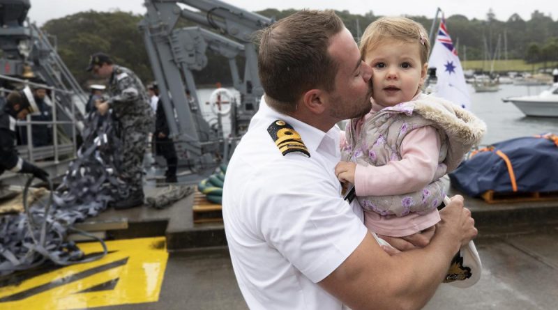 Commanding Officer HMAS Gascoyne, Lieutenant Commander Geoff Crane kisses is daughter on the wharf at HMAS Waterhen following his return home after the completion of a successful deployment. Story by Lieutenant Jessica Craig. Photo by Petty Officer Tom Gibson.