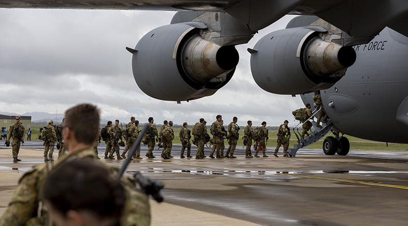 Australian Army soldiers from Joint Task Group 637.3 board a Royal Australian Air Force C-17A Globemaster III at RAAF Base Townsville, Queensland, deploying to the Solomon Islands on 26 November 2021. Photo by Corporal Brandon Grey.
