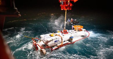 The LR5 submersible is lowered in the water from MV Stoker during night operations off the coast of Rottnest Island in Western Australia as part of Exercise Black Carillon 21. Photo by Chief Petty Officer Damien Pawlenko.