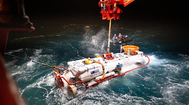 The LR5 submersible is lowered in the water from MV Stoker during night operations off the coast of Rottnest Island in Western Australia as part of Exercise Black Carillon 21. Photo by Chief Petty Officer Damien Pawlenko.