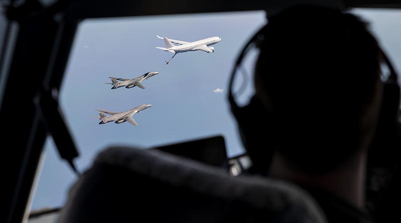 A Royal Australian Air Force KC-30A Multi Role Tanker Transport aircraft and two United States Air Force B-1B Lancer bombers fly in formation over the Northern Territory, watched by the crew of another RAAF MRTT. Photo by Flight Lieutenant Byron Miles-Ward.