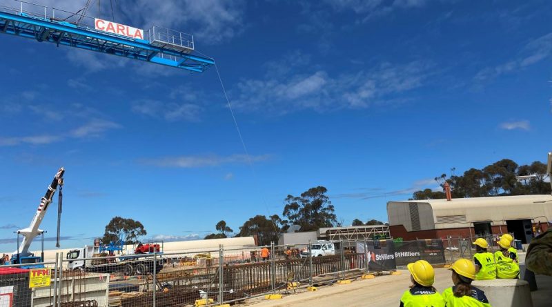 Students from Puckapunyal Primary School watch on as 'Carla the Crane' is erected at the Stage 1 – Armoured Fighting Vehicle Facilities Program project site at the School of Armour. Story by Major Carrie Robards.