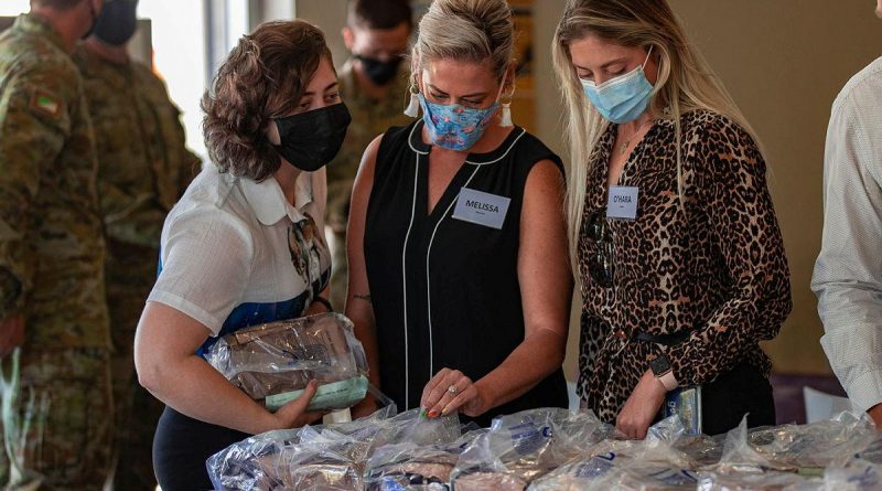Department of Veterans' Affairs staff Caitlin Frost, left, Melissa Morrison and O’Hara Nailon sample a 24-hour ration pack during a visit to Gallipoli Barracks, Brisbane. Story by Captain Jesse Robilliard. Photo by Corporal Nicole Dorrett.