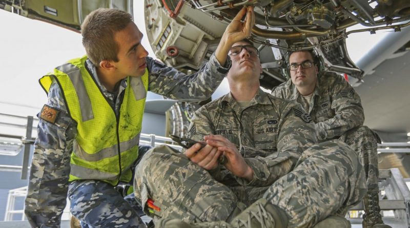 Leading Aircraftman Aaron Kouyoumtzoglou and Staff Sergeant Dustin Sheffield lock wire a fuel filter during the Enhanced Air Cooperation third phase as part of Exercise Pacific Agility. Photo by Corporal Brenton Kwaterski.