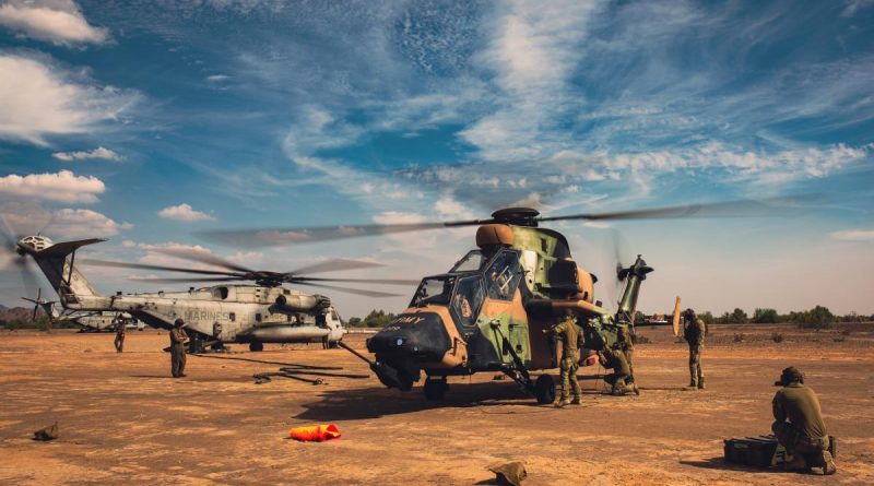 Australian Army Ground Crew Aircraft Support personnel, of the 1st Aviation Regiment, re-arm ARH Tigers at a US Marine Corps CH-53E Super Stallion air deployed ground refuel point, during Exercise Griffin Eagle. Story by Captain Carolyn Barnett. Photo by Captain Gavin Partridge.