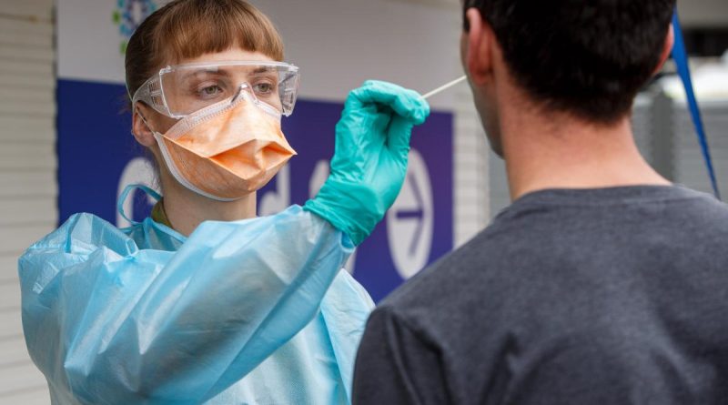 Lieutenant Mia Parsons, of the 1st Close Health Battalion, takes a COVID test sample from a member of the public at the Goulburn Valley Health COVID testing site in Shepparton, Victoria. Story by Major Fiona Bickerstaff. Photo by Private Dustin Anderson.