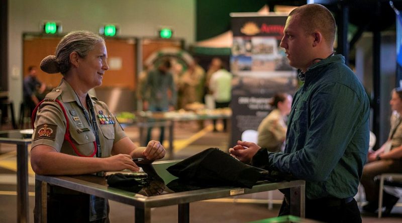 Warrant Officer Class Two Charlotte Hansen, left, of the 20th Regiment, Royal Australian Artillery, talks to Private Zach Holmes, of the 9th Battalion, Royal Queensland Regiment, at the jobs expo in Brisbane. Story by Captain Jesse Robilliard. Photo by Private Jacob Hilton.