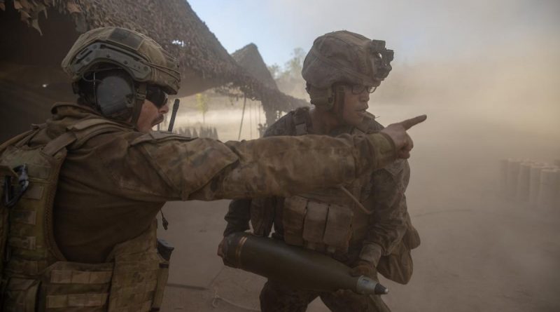 Australian Army Bombardier Damian Williams, left, confirms the ammunition type with United States Marine Corps Lance Corporal Kevin Matias during a live-fire activity as part of Exercise Koolendong. Story by Lieutenant Gordon Carr-Gregg. Photo by Corporal Rodrigo Villablanca.