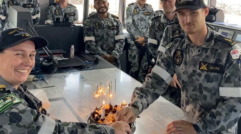 Commanding Officer HMAS Maitland Lieutenant Commander Julia Griffin and Able Seaman Samuel Allen prepare to cut a cake celebrating the Armidale-class patrol boat's 15th birthday. Story by Lieutenant Liam Feenan.