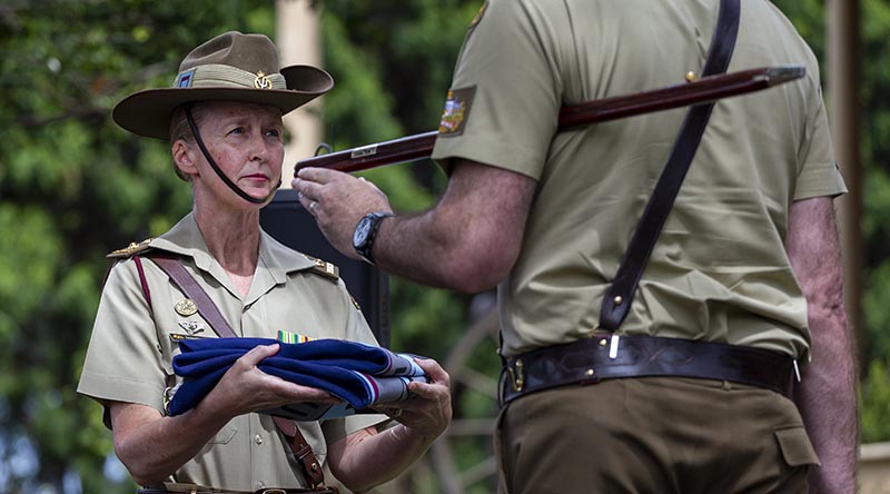 Lieutenant Colonel Jacqueline Costello receives the 1st Phycology Unit's flag from Warrant Officer Class One Craig Webb during a Flag Lowering Ceremony for the 1st Psychology Unit, at Victoria Barracks, Sydney. Photo by Private Jack Brook.